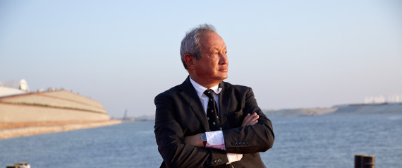 Egyptian billionaire Naguib Sawiris poses for a photograph on a floating pontoon in front of the New Suez Canal, operated by the Suez Canal Authority, in Ismailia, Egypt, on Thursday, Aug. 6, 2015. The expansion will meet future demand, with traffic expected to double to 97 vessels a day by 2023, said Mohab Mameesh, head of the Suez Canal Authority. Photographer: Shawn Baldwin/Bloomberg via Getty Images